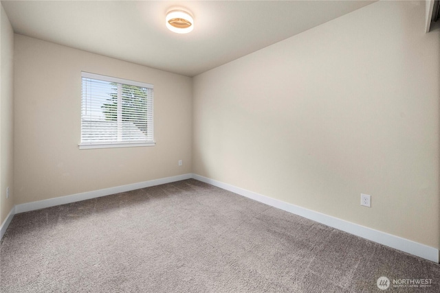 empty room featuring baseboards and carpet floors