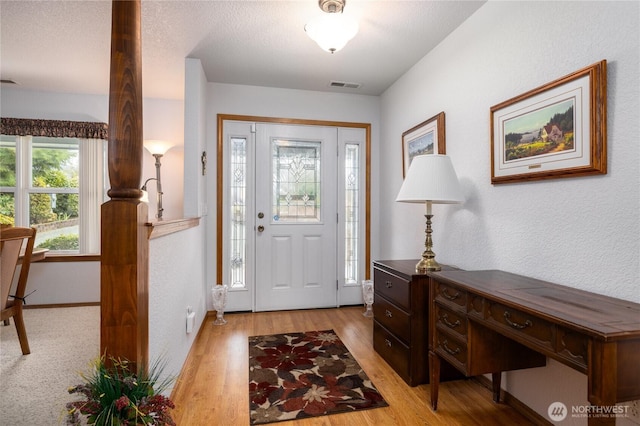 6084 Gartin Pl, Sedro Woolley, WA 98284 - foyer featuring visible vents, a textured ceiling, light wood-style floors, and a textured wall