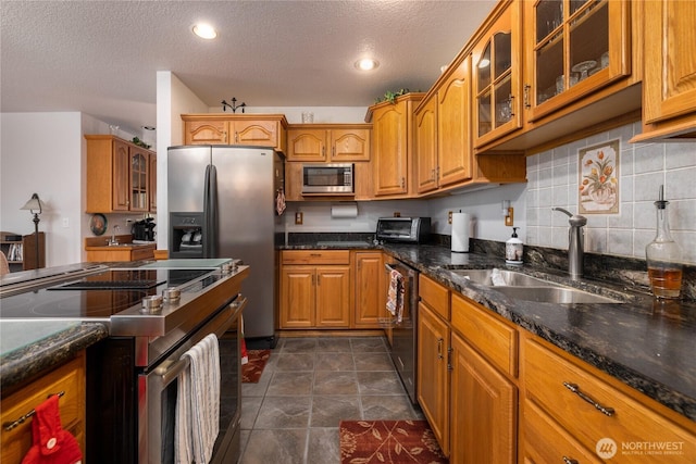 6084 Gartin Pl, Sedro Woolley, WA 98284 - kitchen with a sink, glass insert cabinets, brown cabinetry, and stainless steel appliances