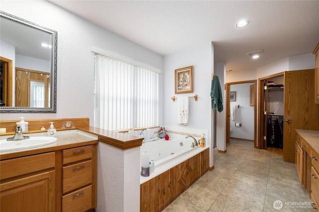 6084 Gartin Pl, Sedro Woolley, WA 98284 - full bath featuring vanity, recessed lighting, a whirlpool tub, a spacious closet, and tile patterned floors