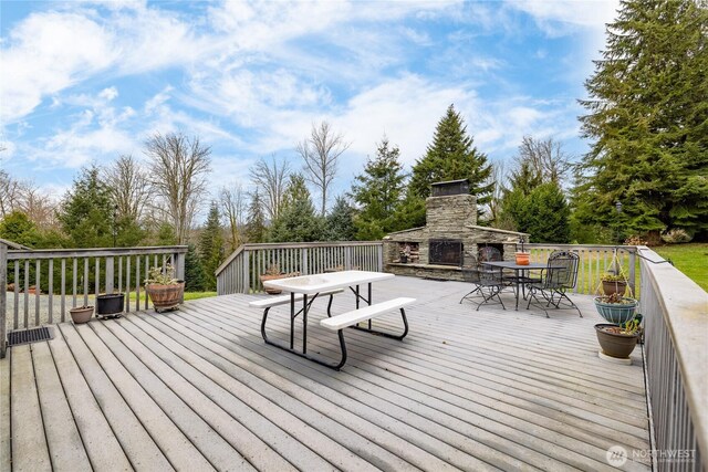 6084 Gartin Pl, Sedro Woolley, WA 98284 - deck featuring outdoor dining area and an outdoor stone fireplace