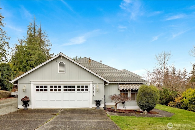 single story home with aphalt driveway, a front lawn, and an attached garage