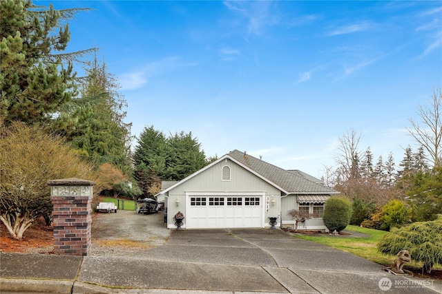 view of home's exterior with an attached garage, driveway, and a shingled roof