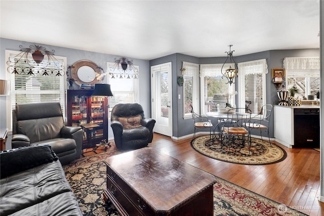 living area with hardwood / wood-style flooring and baseboards