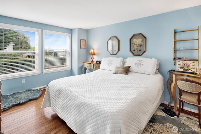 bedroom featuring baseboards and hardwood / wood-style flooring