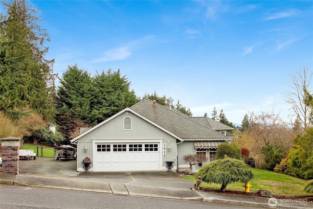 view of front of home with a front lawn, concrete driveway, and a garage