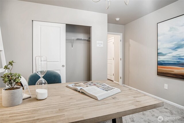 interior space featuring a closet and baseboards