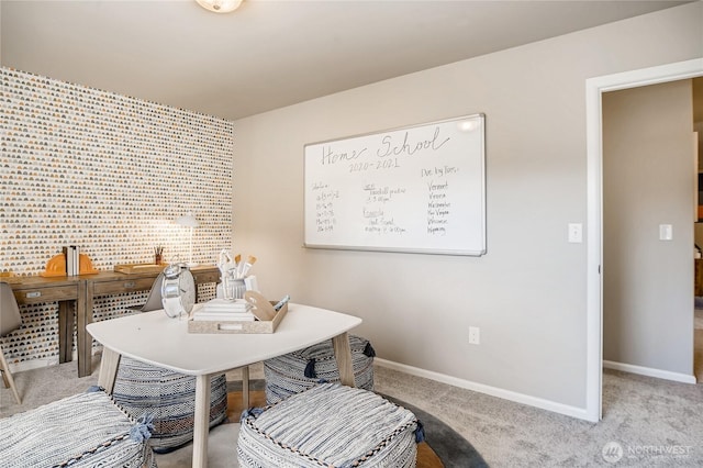 dining area with baseboards and light colored carpet