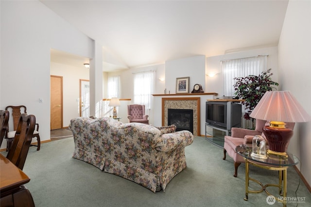 carpeted living room with lofted ceiling, a fireplace, and baseboards