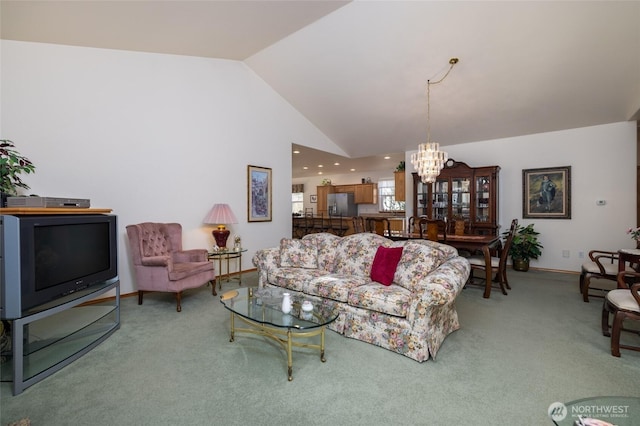 living room featuring an inviting chandelier, light colored carpet, baseboards, and high vaulted ceiling