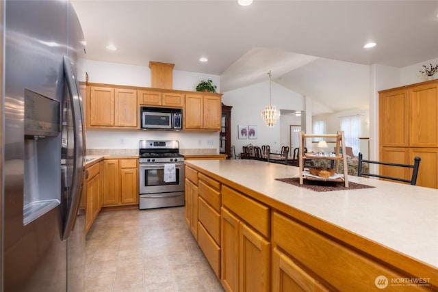 kitchen with recessed lighting, stainless steel appliances, pendant lighting, and light countertops