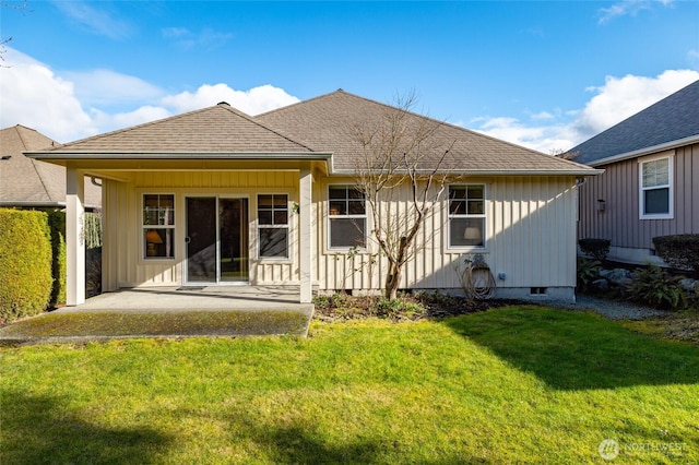 back of property featuring crawl space, a lawn, board and batten siding, and roof with shingles