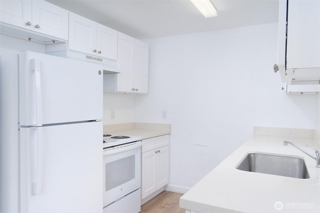 kitchen with a sink, white appliances, light countertops, and white cabinetry