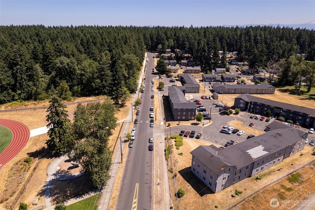 drone / aerial view featuring a view of trees