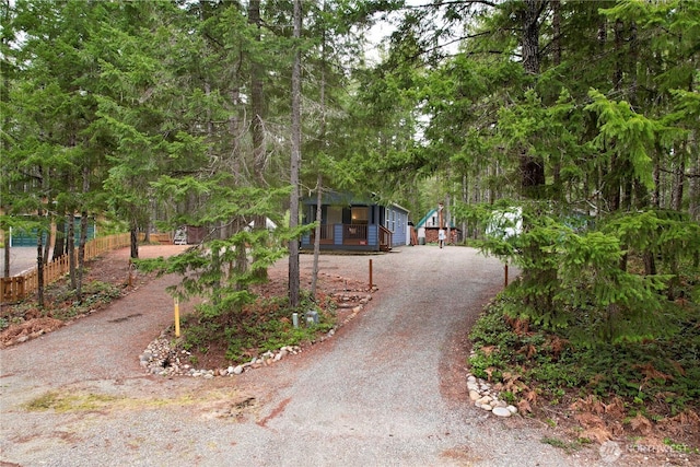 surrounding community with driveway and fence