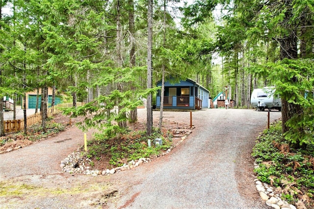 view of front facade featuring driveway and fence