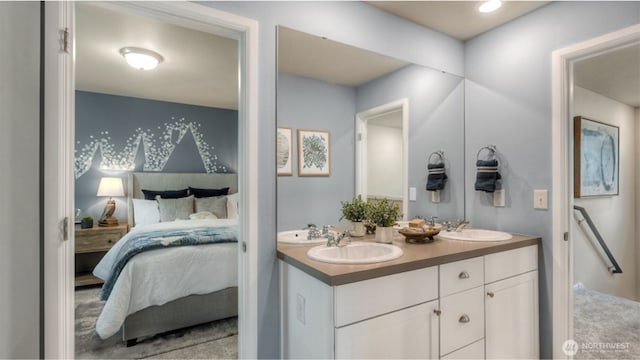 full bath with a sink, ensuite bath, and double vanity