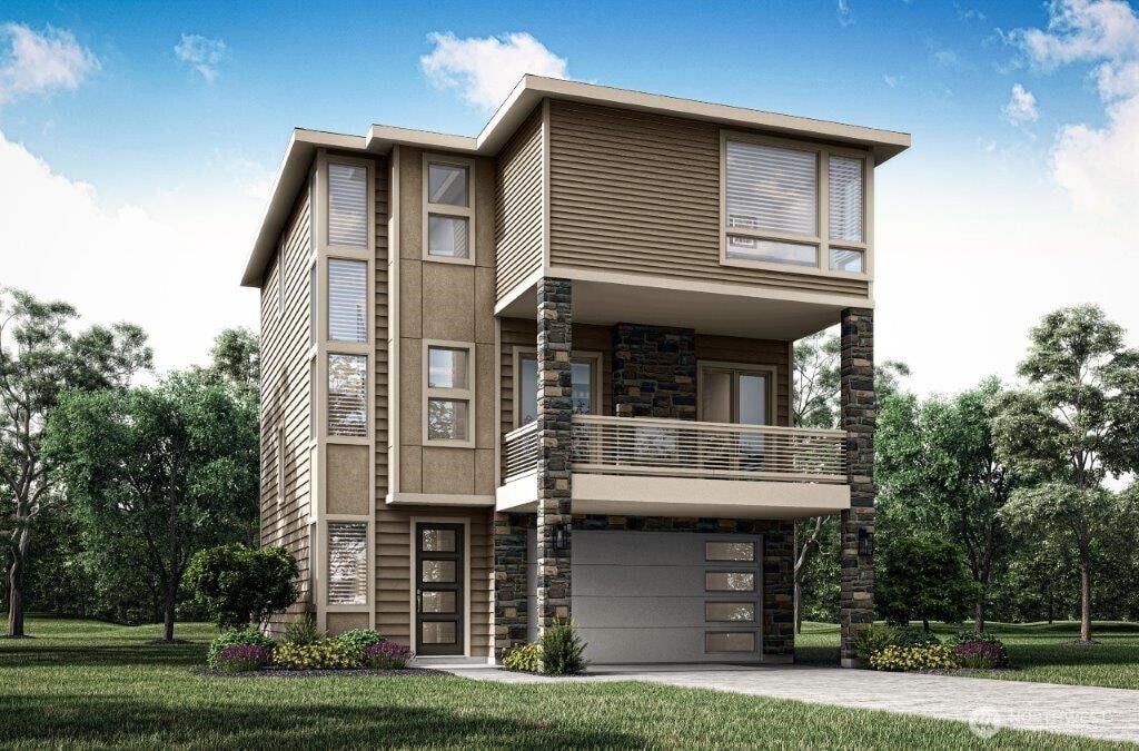 view of front of property featuring a garage, a front yard, a balcony, and driveway