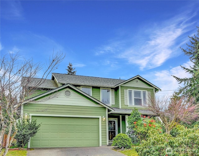 view of front of property featuring aphalt driveway, a garage, and a shingled roof