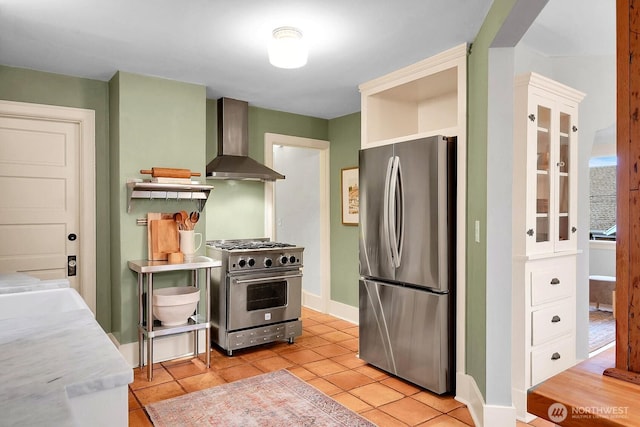 kitchen featuring open shelves, appliances with stainless steel finishes, light tile patterned flooring, white cabinets, and wall chimney range hood