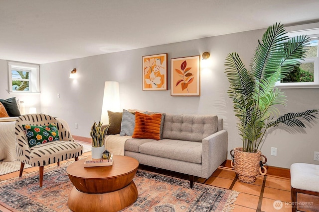 tiled living room featuring baseboards