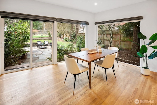 dining room with recessed lighting and light wood-type flooring