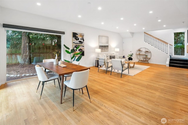 dining area featuring recessed lighting, light wood-style flooring, and stairs