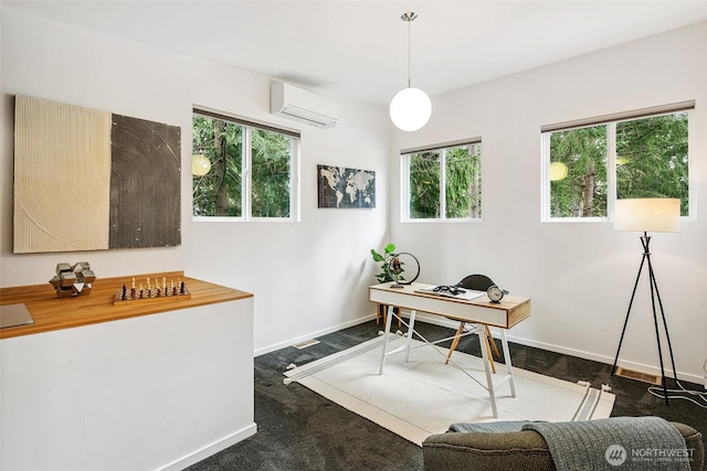 office area with an AC wall unit, baseboards, and dark carpet