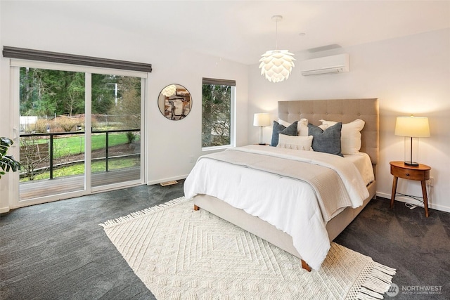 carpeted bedroom featuring access to exterior, baseboards, and a wall unit AC