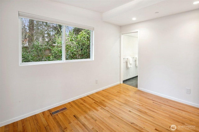 empty room featuring recessed lighting, visible vents, baseboards, and light wood finished floors