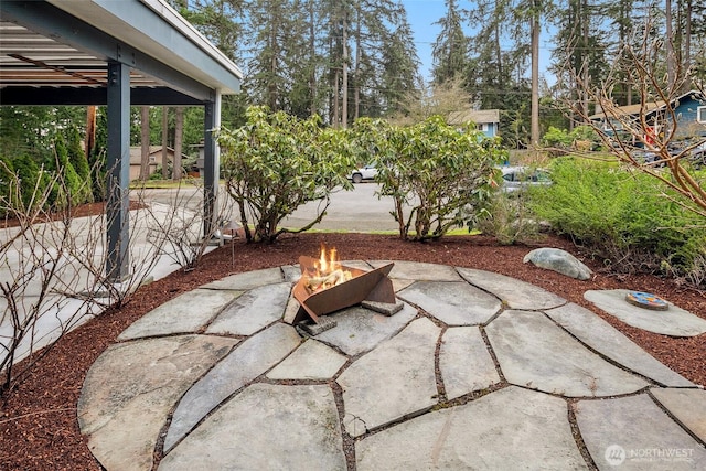 view of patio / terrace featuring an outdoor fire pit