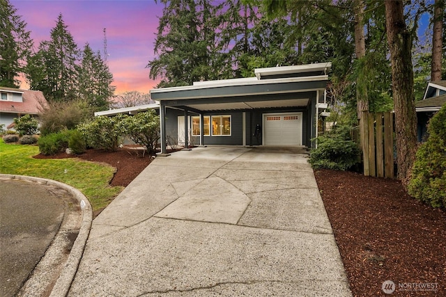 garage with an attached carport and driveway