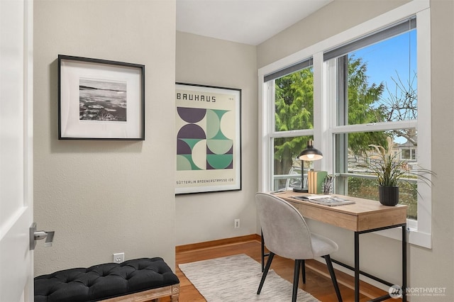 office space with wood finished floors and baseboards