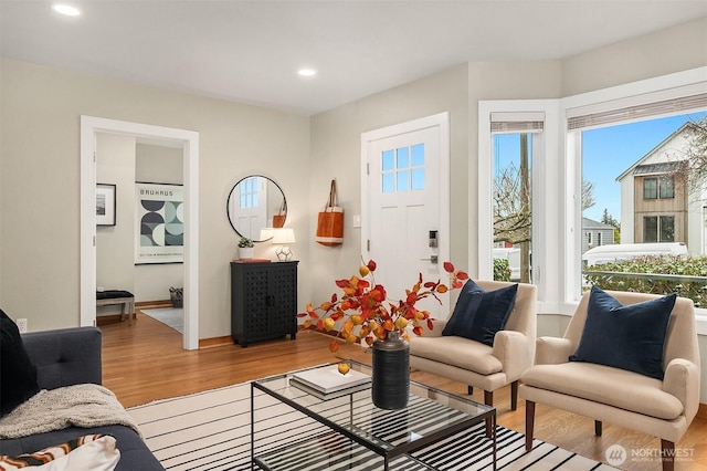 living area with recessed lighting and light wood-type flooring