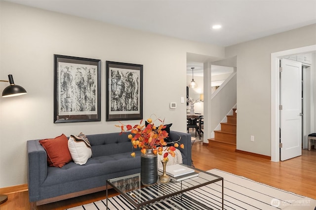 living room featuring stairway, recessed lighting, wood finished floors, and baseboards