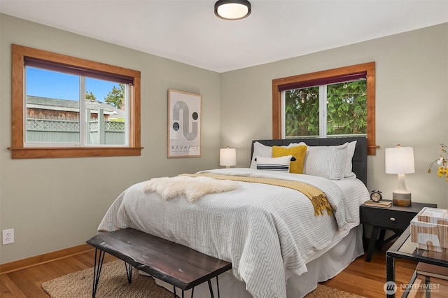 bedroom with wood finished floors and baseboards