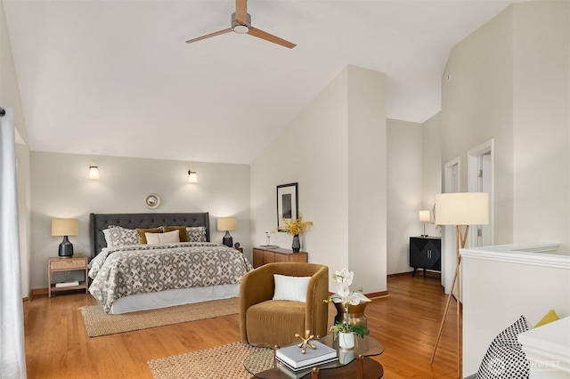 bedroom with baseboards, high vaulted ceiling, and wood finished floors