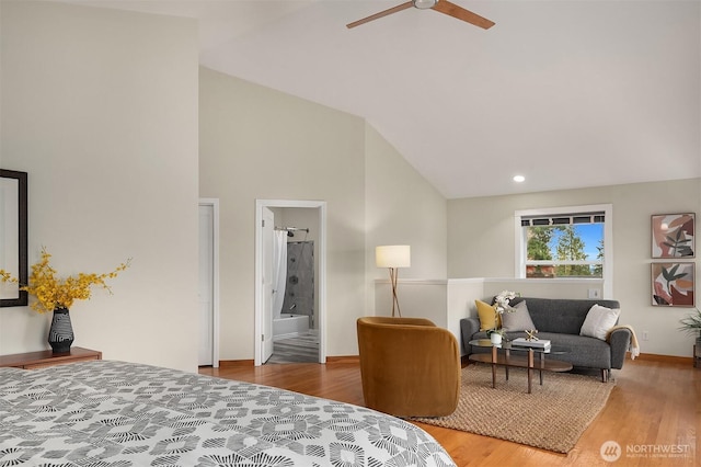 bedroom featuring recessed lighting, connected bathroom, high vaulted ceiling, and wood finished floors