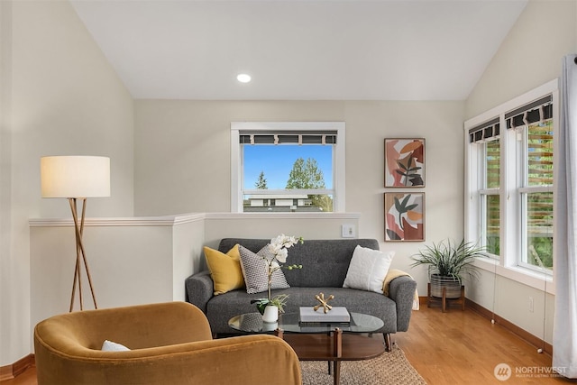 living area with recessed lighting, baseboards, lofted ceiling, and wood finished floors