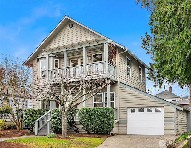 view of front of home featuring concrete driveway and a balcony