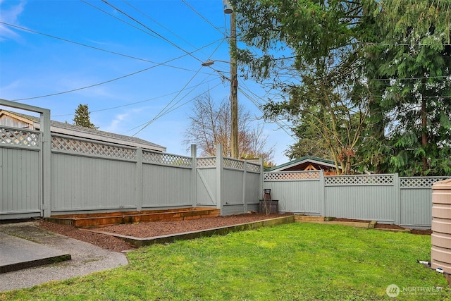 view of yard featuring a gate and a fenced backyard