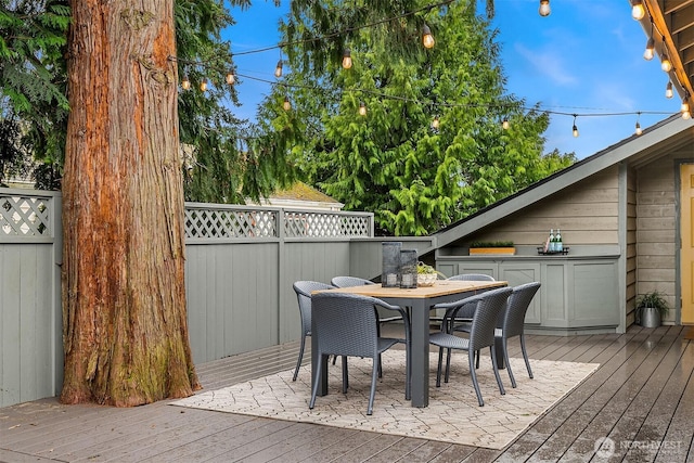 wooden deck featuring outdoor dining space and fence