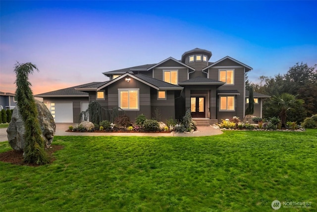 view of front of house with a garage, driveway, and a yard