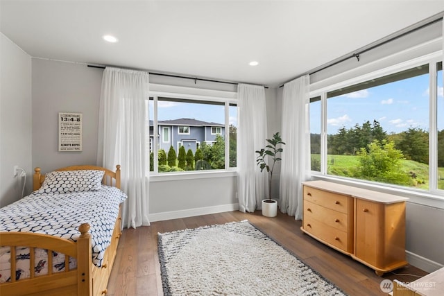 bedroom featuring recessed lighting, multiple windows, baseboards, and wood finished floors