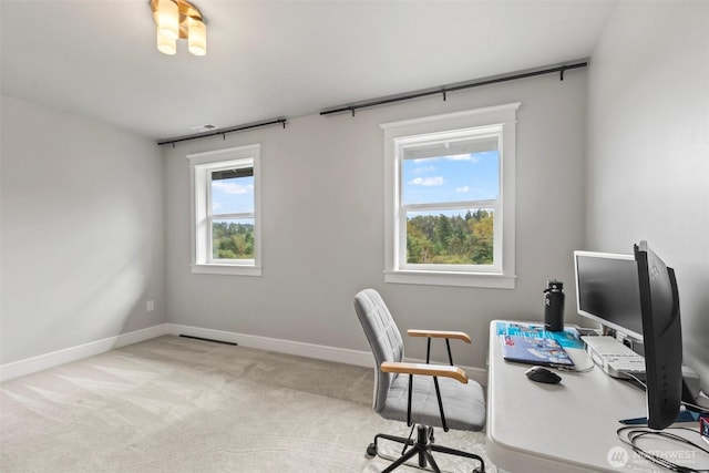 office area featuring carpet flooring, visible vents, and baseboards