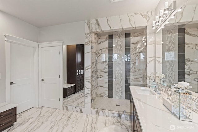 full bathroom featuring vanity, marble finish floor, and walk in shower