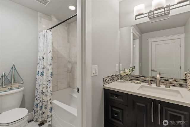 full bath with vanity, visible vents, shower / bath combo, toilet, and backsplash