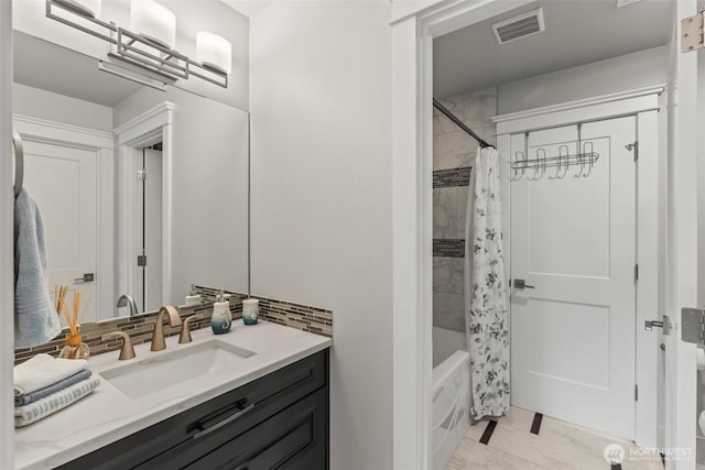 bathroom with visible vents, backsplash, shower / bath combination with curtain, vanity, and marble finish floor