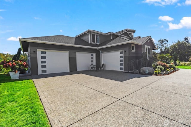 view of front of house with concrete driveway, an attached garage, and a shingled roof