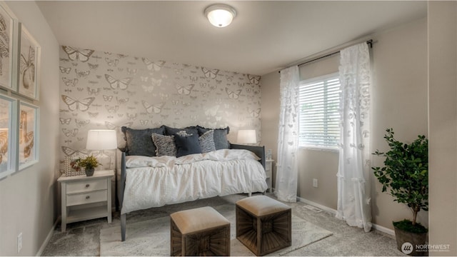 carpeted bedroom featuring wallpapered walls and baseboards